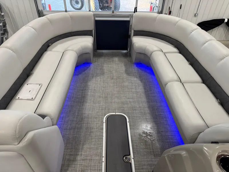 Slide: The Image of 2018 Lund LX 240 boat interior with gray seating and blue LED lighting. - 11
