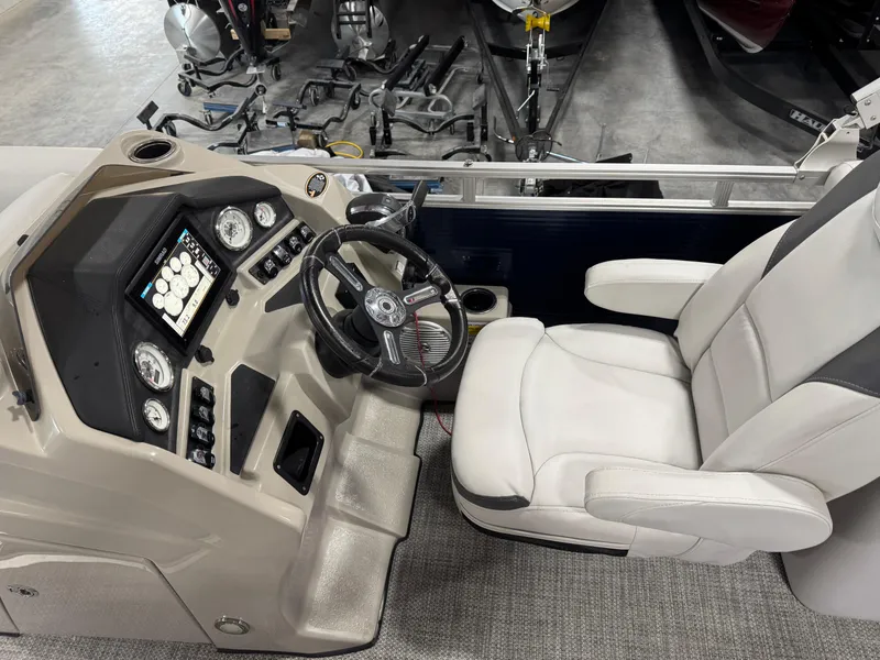 Slide: The Image of 2018 Lund LX 240 boat interior with steering console and captain's chair. - 12