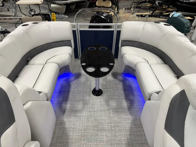 Slide: The Image of 2018 Lund LX 240 boat interior with plush seating and ambient blue lighting. - 13