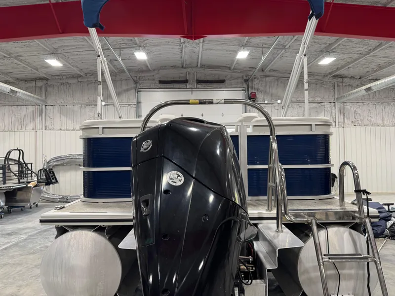 Slide: The Image of 2018 Lund LX 240 pontoon boat with outboard motor in a warehouse setting. - 5