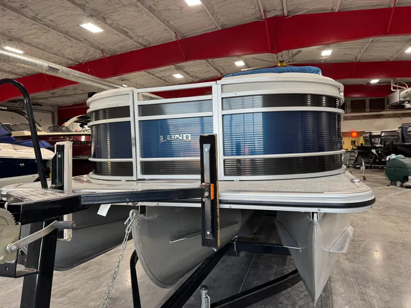 Slide: The Image of 2018 Lund LX 240 pontoon boat in showroom, side view. - 6