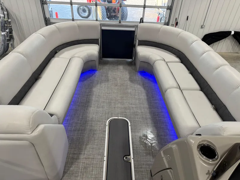 Slide: The Image of 2018 Lund LX 240 boat interior with gray seating and blue LED lighting. - 9