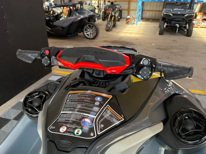 Slide: The Image of 2024 Sea-Doo RXT-X 325 Tech Package handlebar view in a garage. - 6