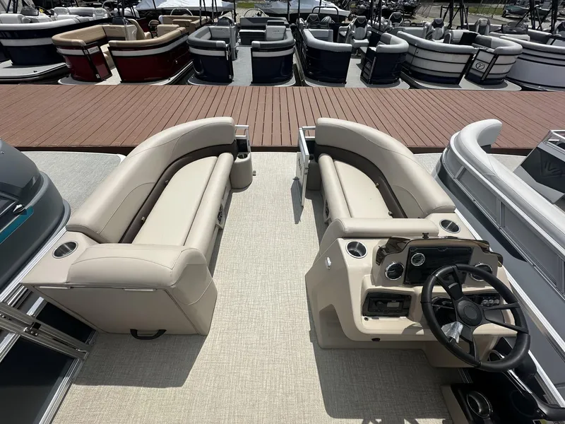 Slide: The Image of 2025 Avalon VLS pontoon boat interior with beige seating and modern dashboard. - 3