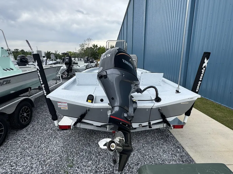 Slide: The Image of 2025 Xpress Hyper-Lift Series H20B boat with Yamaha outboard motor, parked on gravel. - 2