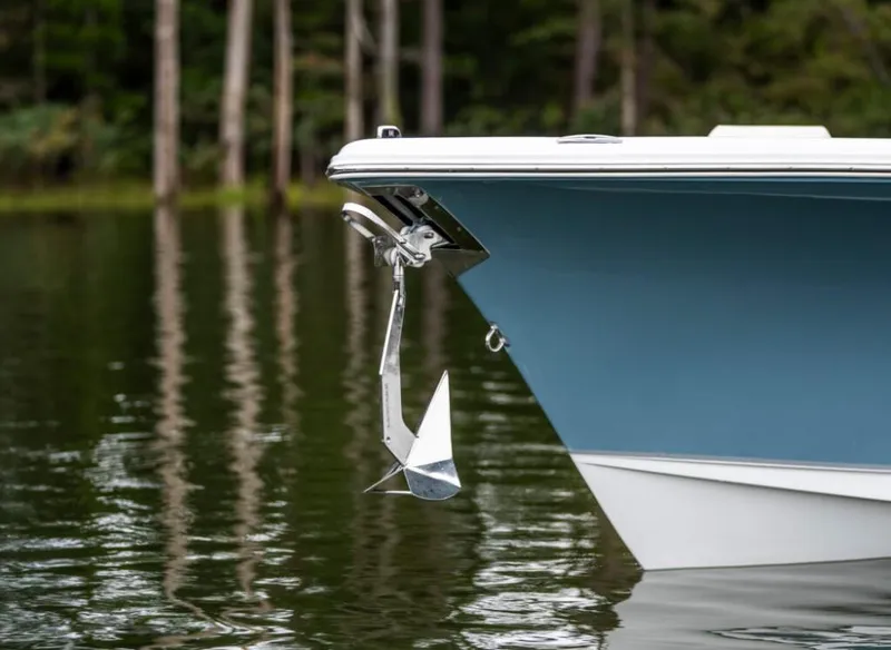 Slide: The Image of 2025 Sea Hunt Ultra 245 SE boat with anchor on calm water. - 4