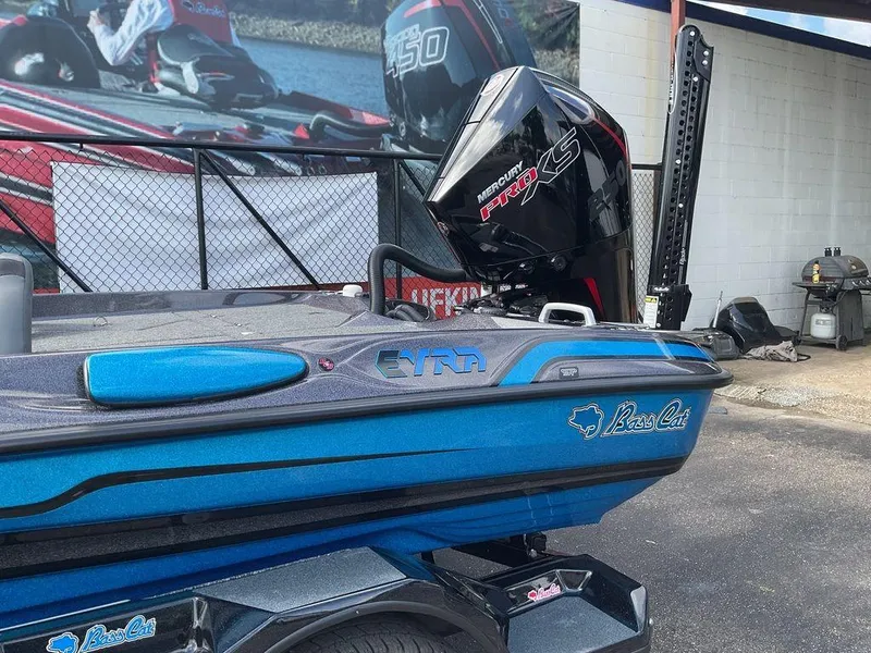 Slide: The Image of 2025 Bass Cat Eyra boat with Mercury Pro XS engine, blue finish, parked outdoors. - 10