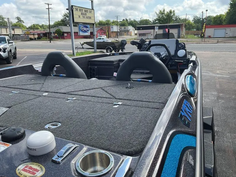 Slide: The Image of 2025 Bass Cat Eyra boat with advanced Garmin navigation system, parked outdoors. - 14