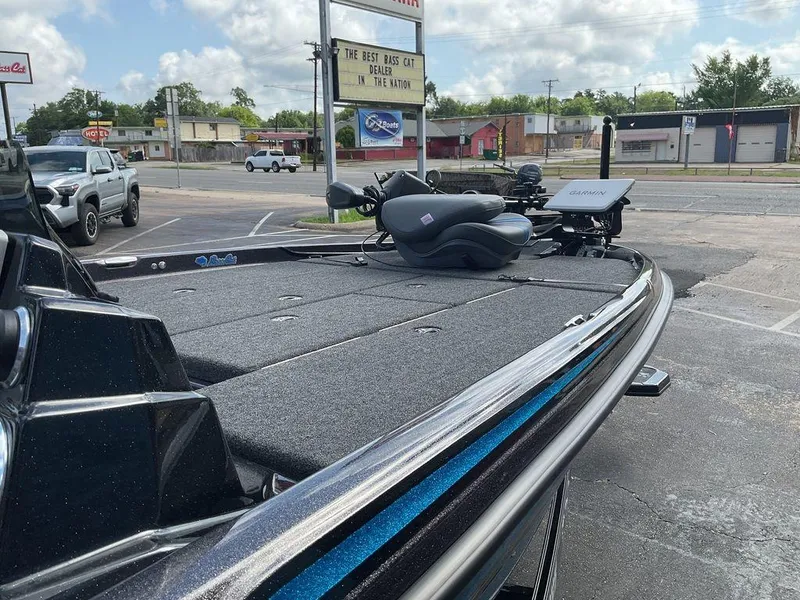 Slide: The Image of 2025 Bass Cat Eyra boat with advanced navigation system, parked in dealership lot. - 18