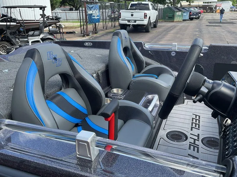 Slide: The Image of 2025 Bass Cat Eyra boat interior with blue-accented seats and steering wheel. - 20