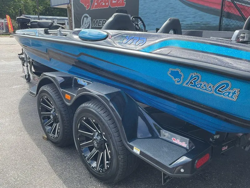 Slide: The Image of 2025 Bass Cat Eyra boat with sleek blue design and stylish wheels. - 22