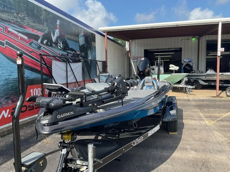 Slide: The Image of 2025 Bass Cat Eyra boat with Garmin equipment, parked outside a dealership. - 4