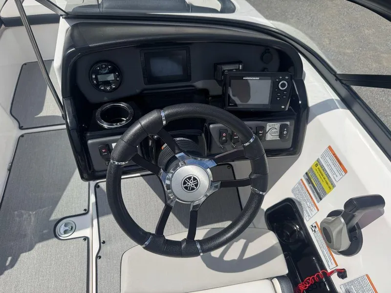 Slide: The Image of 2021 Yamaha AR195 boat dashboard with steering wheel and control panel. - 3