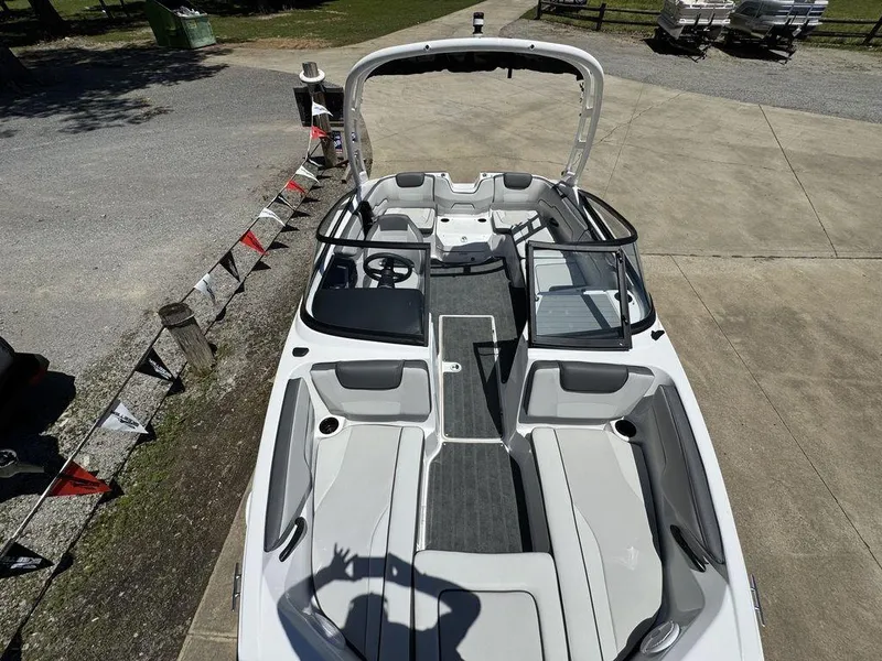 Slide: The Image of 2024 Yamaha Boats AR190, sleek interior design, parked outdoors on concrete surface. - 5