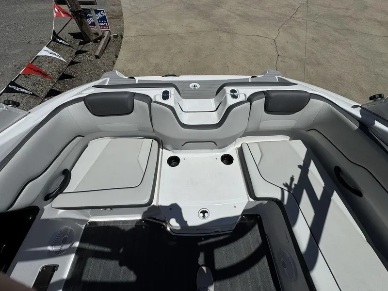 Slide: The Image of 2024 Yamaha Boats AR190 interior seating area with cup holders and cushions. - 8