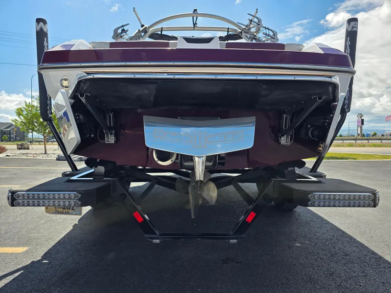 Slide: The Image of Rear view of a 2020 Malibu 21VLX boat on a trailer, showcasing the propeller and wedge. - 10
