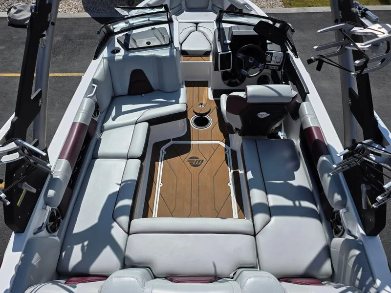 Slide: The Image of 2020 Malibu 21VLX boat interior with luxurious seating and modern dashboard. - 12
