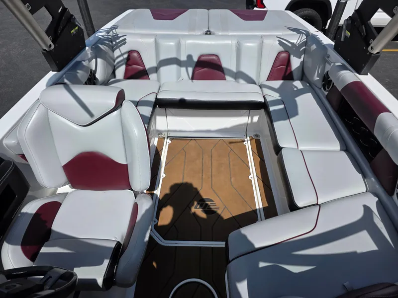 Slide: The Image of Interior of a 2020 Malibu 21VLX boat with white and maroon seating. - 14