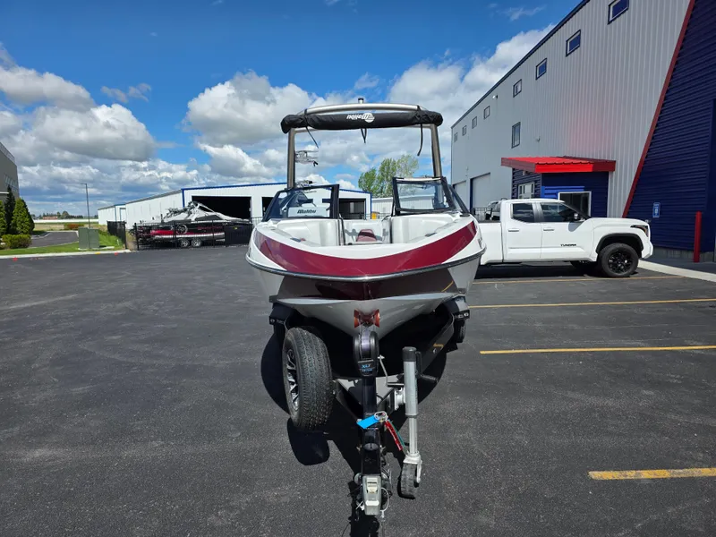 Slide: The Image of 2020 Malibu 21VLX boat on trailer in parking lot, sunny day, industrial background. - 4