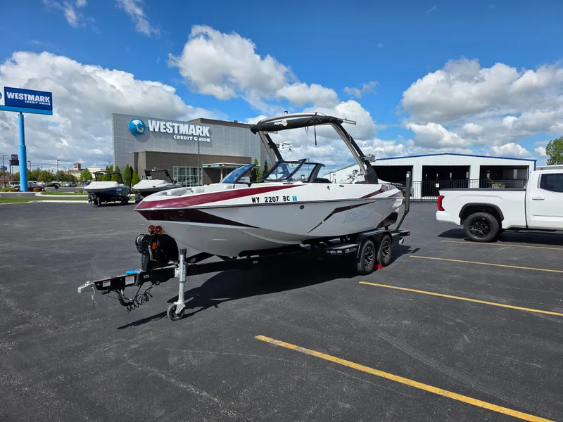 Slide: The Image of 2020 Malibu 21VLX boat on trailer in parking lot, Westmark Credit Union in background. - 5