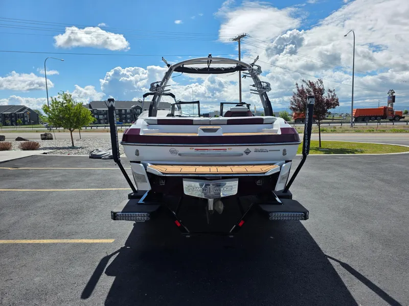 Slide: The Image of 2020 Malibu 21VLX boat parked on asphalt under a bright blue sky. - 8