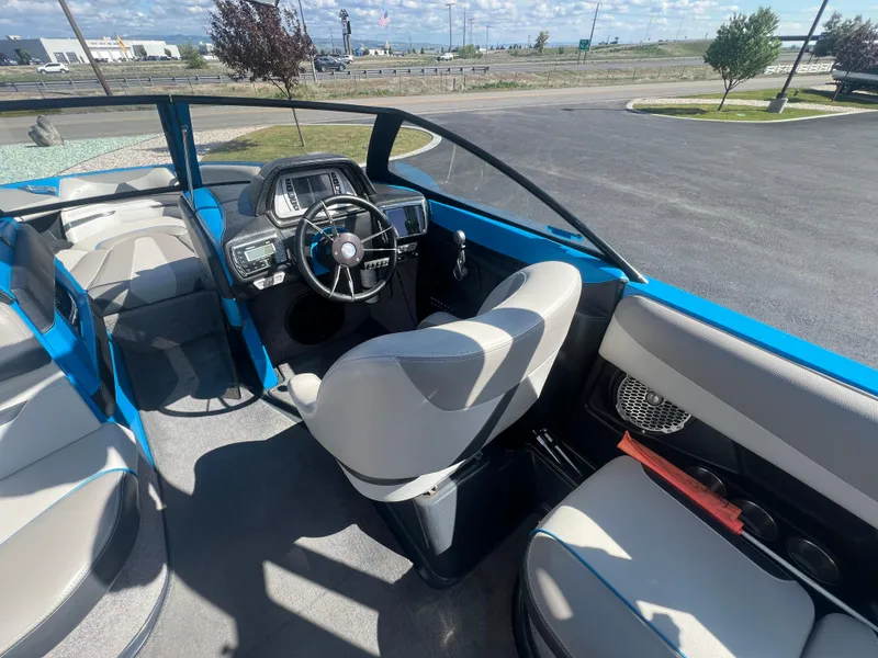 Slide: The Image of 2014 Malibu W23LSV boat interior with blue accents and modern dashboard. - 10