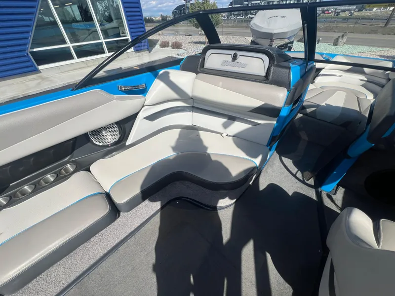 Slide: The Image of Interior of a 2014 Malibu W23LSV boat with sleek seating and modern design. - 12
