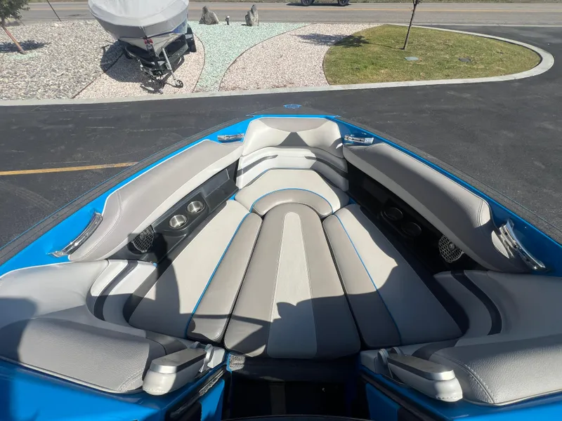 Slide: The Image of Interior of 2014 Malibu W23LSV boat with gray and blue seating. - 15