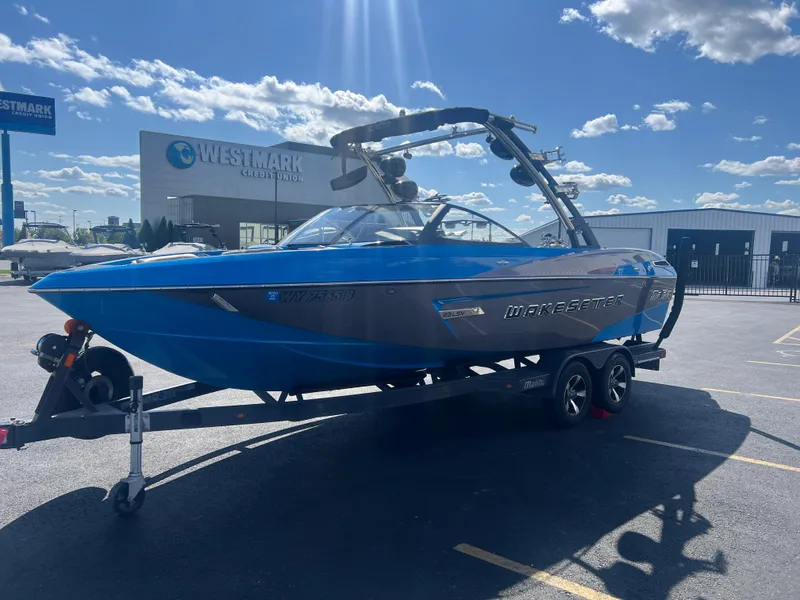 Slide: The Image of 2014 Malibu W23LSV boat on trailer at Westmark Credit Union parking lot. - 4
