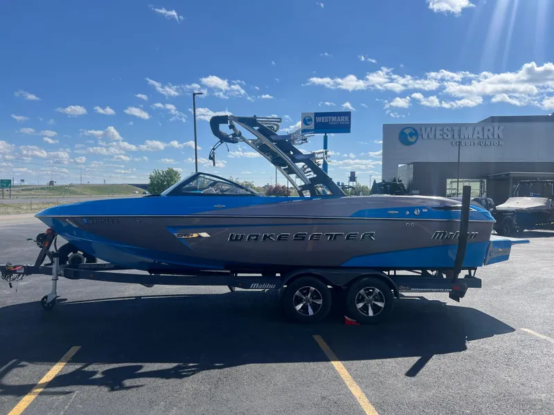 Slide: The Image of 2014 Malibu Wakesetter W23LSV boat on trailer, parked outside Westmark Credit Union. - 5