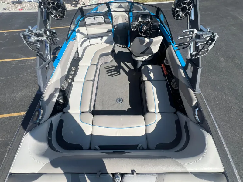 Slide: The Image of 2014 Malibu W23LSV boat interior with seating, speakers, and steering wheel. - 9