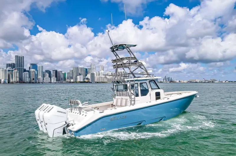 Slide: The Image of 2025 Solace 37 PILOT boat cruising near city skyline under cloudy sky. - 11