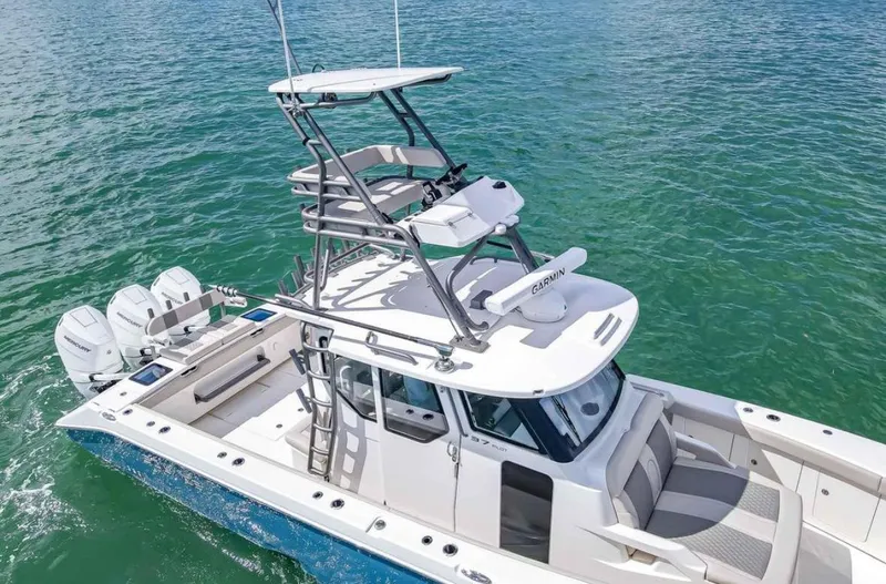 Slide: The Image of 2025 Solace 37 PILOT boat on clear water, featuring multiple outboard engines. - 3