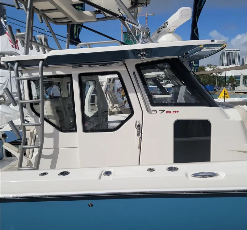 Slide: The Image of 2025 Solace 37 PILOT boat with sleek design and modern features, docked at marina. - 4
