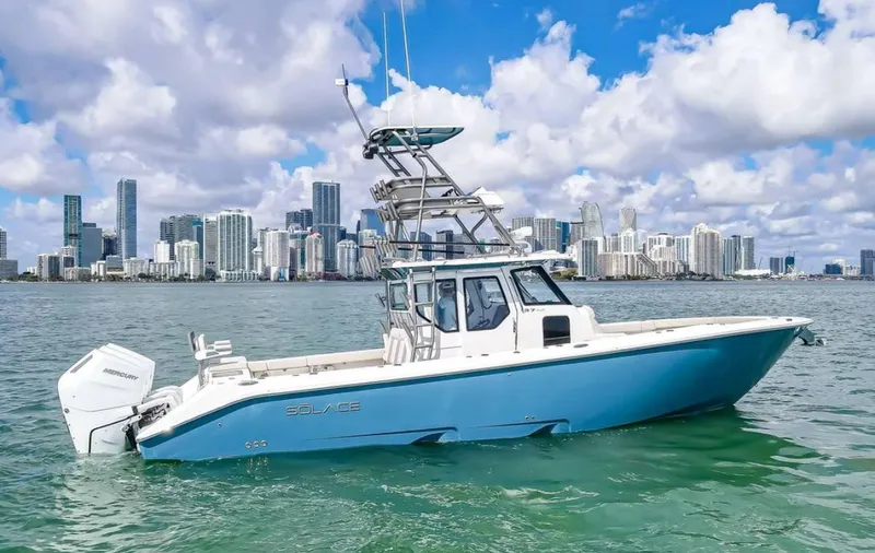 Slide: The Image of 2025 Solace 37 PILOT boat on water with city skyline in background. - 7