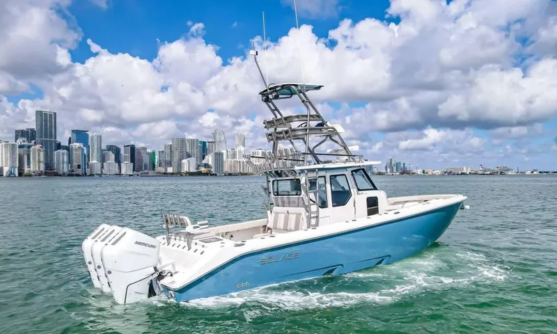 Slide: The Image of 2025 Solace 37 PILOT boat cruising near city skyline under blue sky. - 8