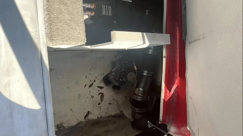 Slide: The Image of 2002 Crownline 225LPX engine compartment with visible components and wiring. - 10