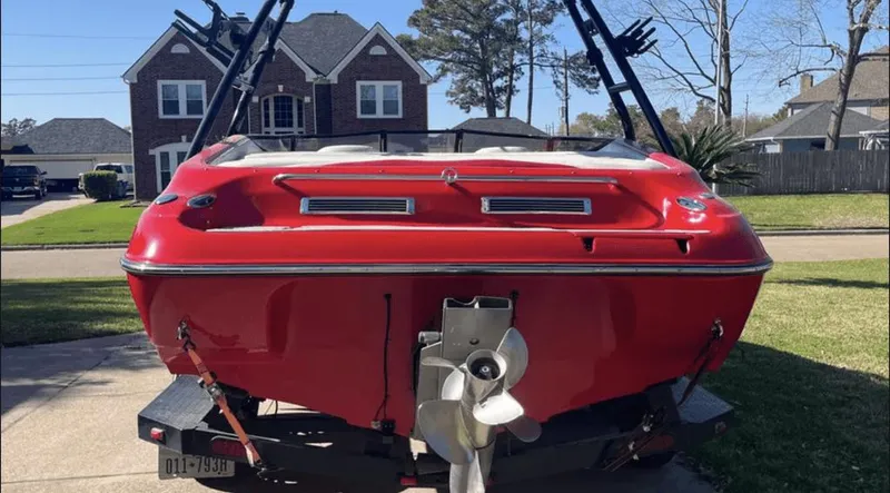 Slide: The Image of Red 2002 Crownline 225LPX boat on trailer in suburban driveway. - 3