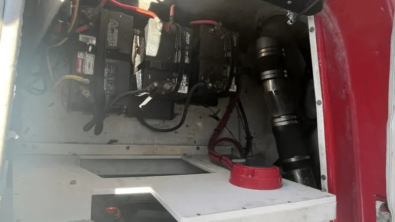 Slide: The Image of 2002 Crownline 225LPX boat battery compartment with wiring and components. - 9
