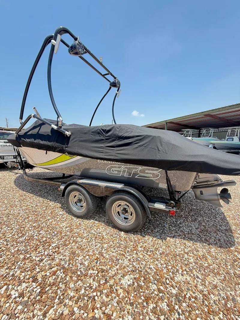 Slide: The Image of 2017 Glastron GTS 205 boat on trailer, covered, parked on gravel under clear sky. - 7