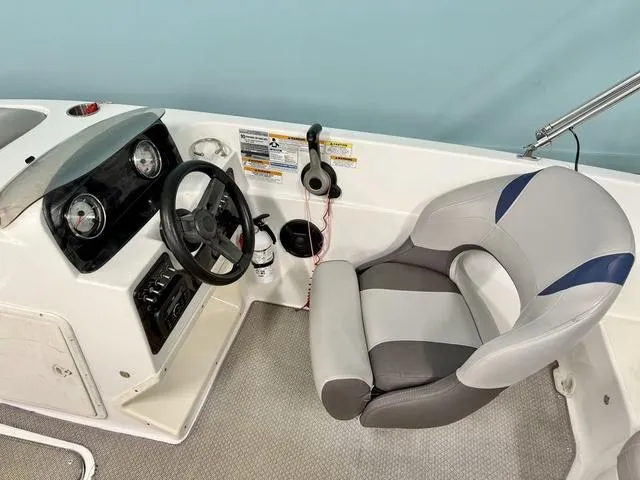 Slide: The Image of 2018 Hurricane SS 188 OB boat cockpit with steering wheel and cushioned seat. - 4