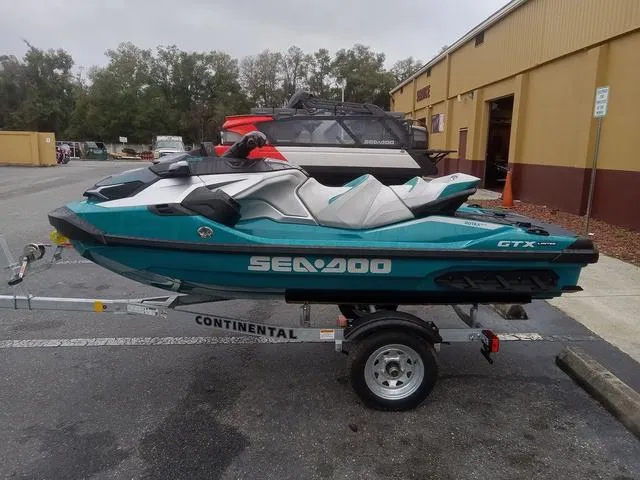 Slide: The Image of 2025 Sea-Doo GTX Waverunner on trailer, parked outside a building. - 10
