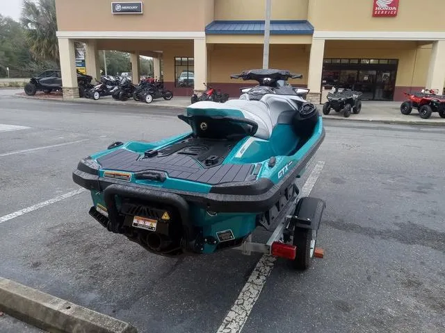 Slide: The Image of 2025 Sea-Doo Waverunner GTX parked on a trailer in a lot. - 13