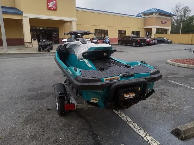 Slide: The Image of 2025 Sea-Doo Waverunner GTX parked on trailer in a commercial parking lot. - 18