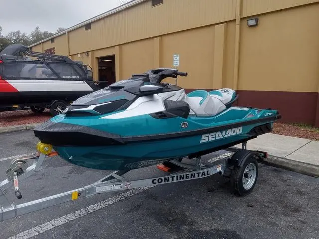 Slide: The Image of 2025 Sea-Doo Waverunner GTX on trailer, parked outside a building. - 8