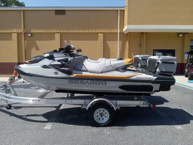 Slide: The Image of 2025 Sea-Doo Waverunner FISH PRO on trailer, parked outdoors. - 13