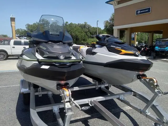 Slide: The Image of 2025 Sea-Doo Waverunner FISH PRO models on trailer, parked outdoors. - 4