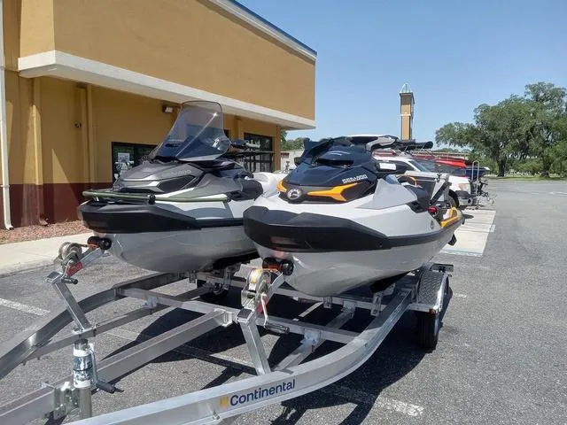 Slide: The Image of 2025 Sea-Doo Waverunner FISH PRO jet skis on a trailer in a parking lot. - 6