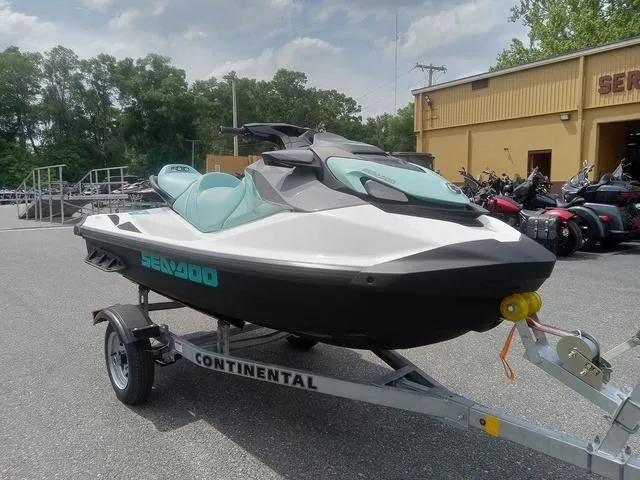 Slide: The Image of 2025 Sea-Doo Waverunner GTI on trailer, parked outdoors near a dealership. - 3