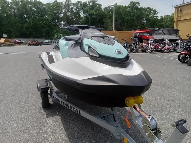 Slide: The Image of 2025 Sea-Doo Waverunner GTI on trailer, parked outdoors with motorcycles in background. - 4